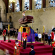 Image for article titled Brits Take Turns Mourning Atop Queen’s Bucking Casket